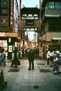 A man stands in the middle of crowd looking a bit lost