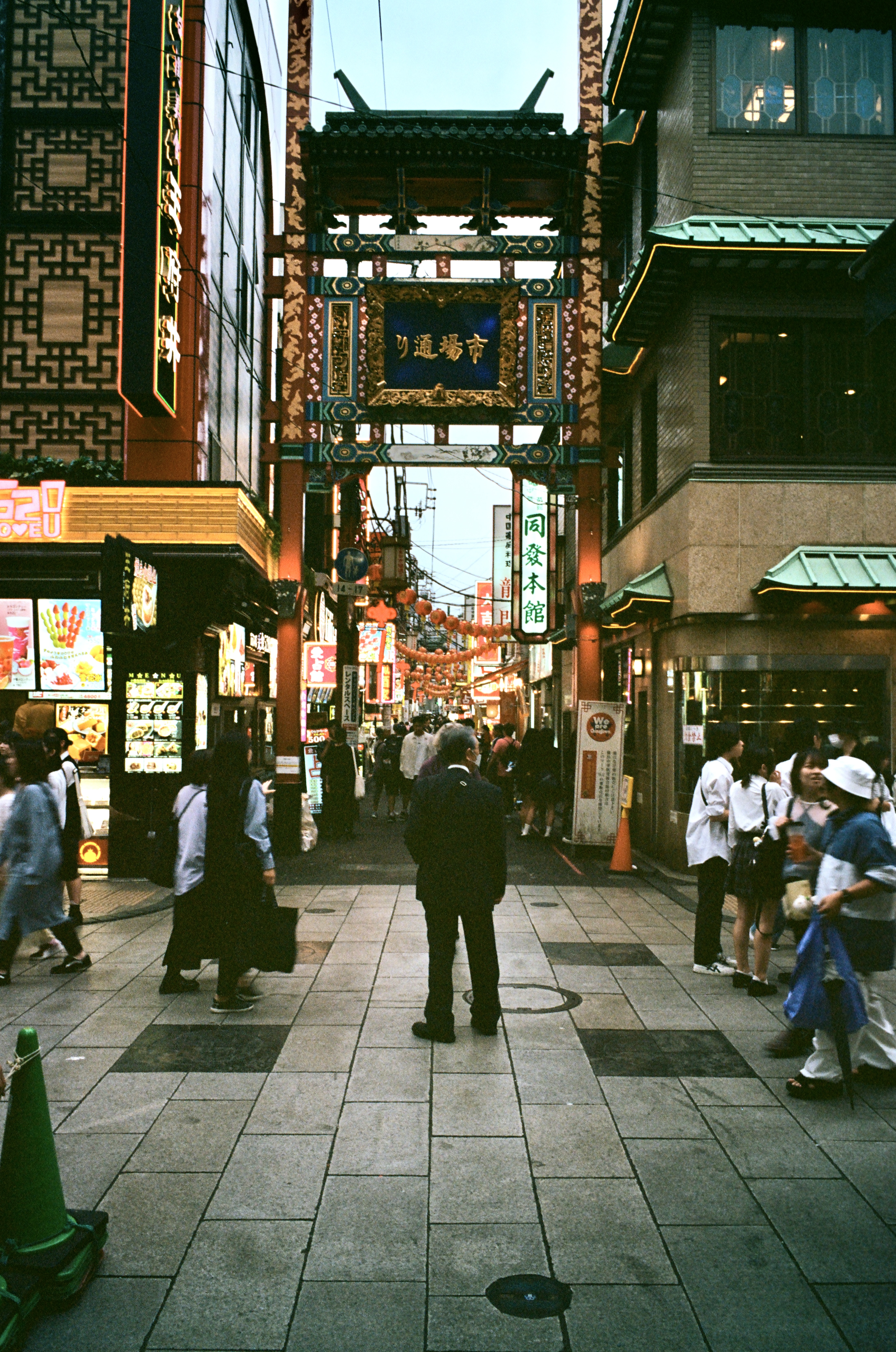 A man stands in the middle of crowd looking a bit lost