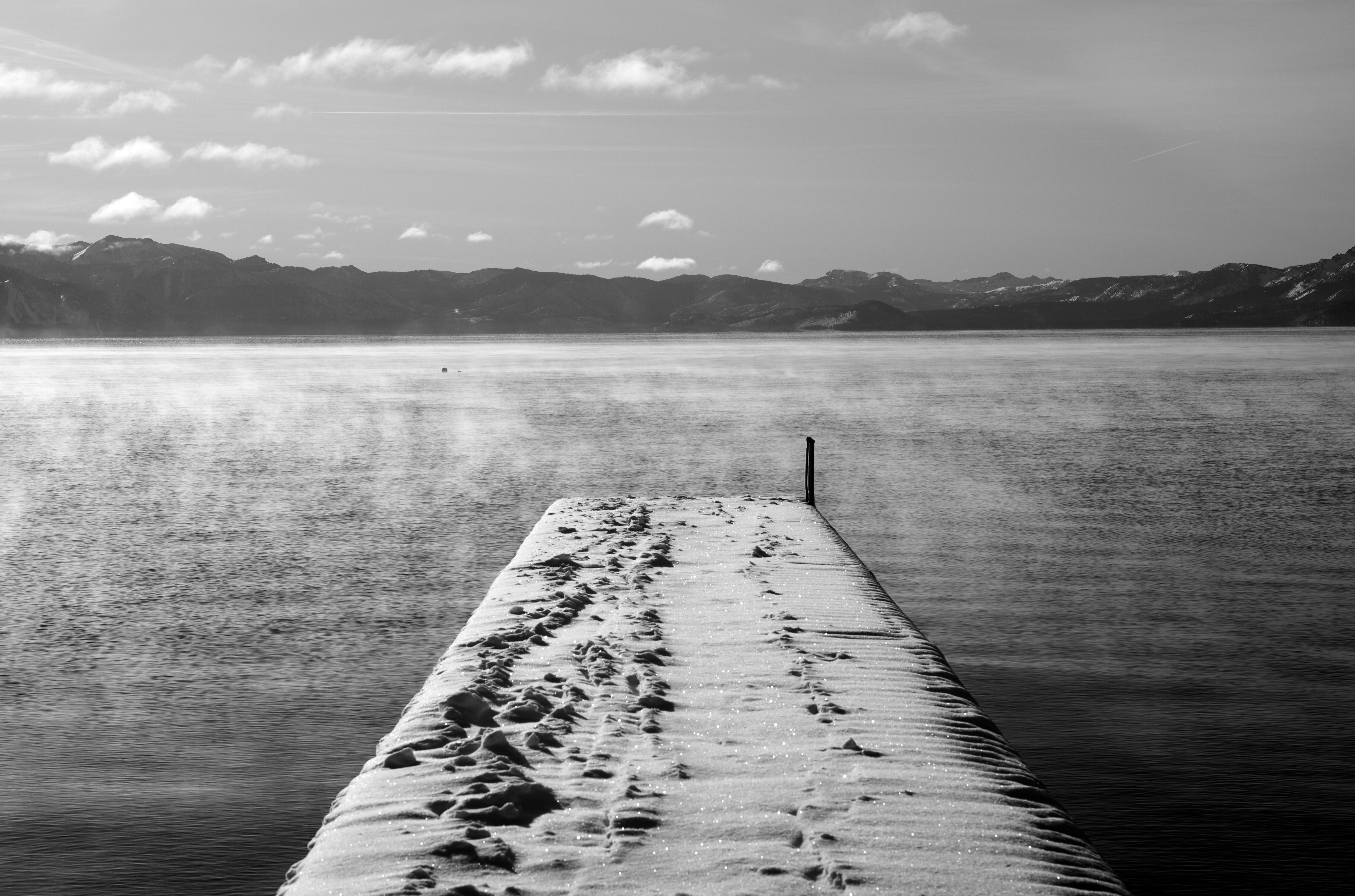 A pier glistens from the snow in Lake Tahoe, California.